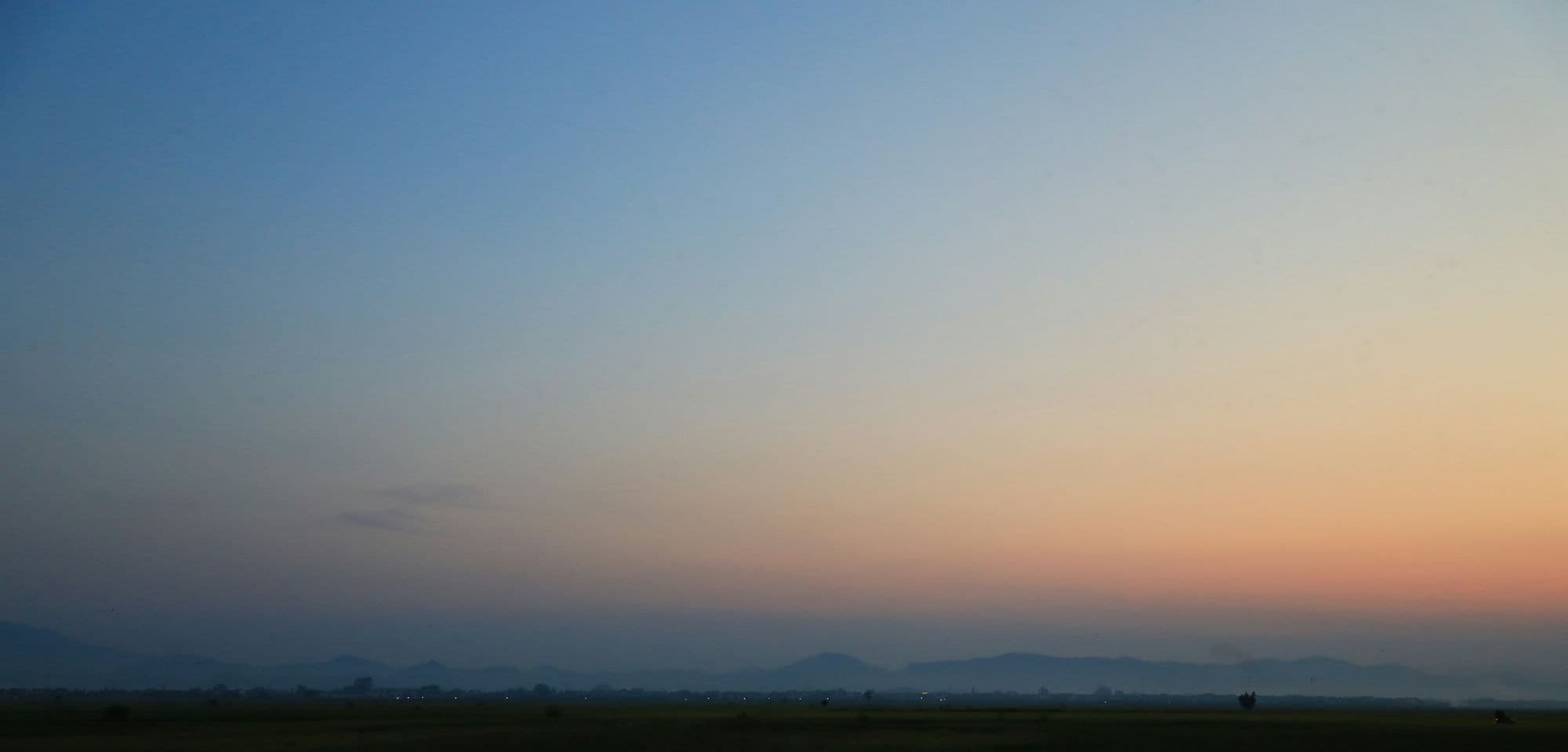 A dusk sky over distant hills